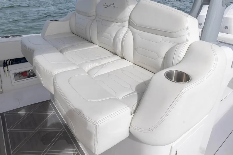 Slide: The Image of Luxurious seating on 2024 Blackwater 43 Sportfish boat with white upholstery and cup holder. - 54