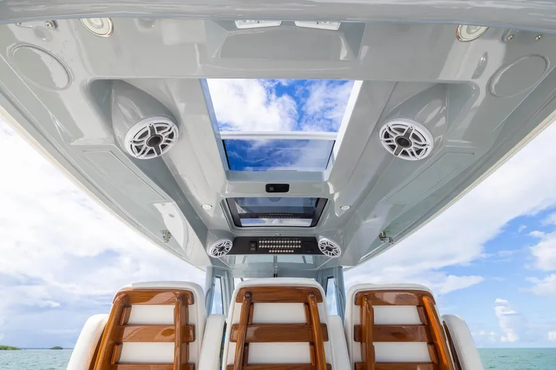 Slide: The Image of 2024 Blackwater 43 Sportfish boat interior with skylight and speakers, showcasing luxury design. - 58