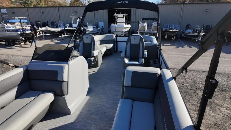 Slide: The Image of 2025 Viaggio V22U pontoon boat with spacious seating and modern design at a dealership. - 15