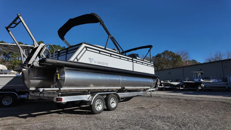 Slide: The Image of 2025 Viaggio V22U pontoon boat on trailer under clear blue sky. - 4