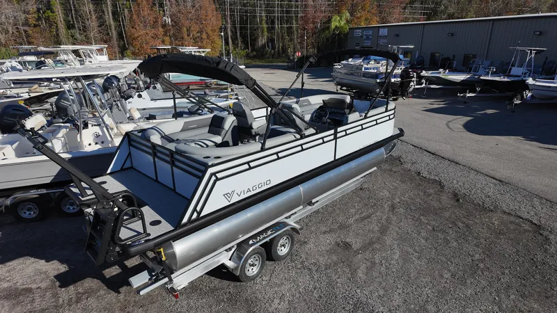 Slide: The Image of 2025 Viaggio V22U pontoon boat on trailer in marina setting. - 5