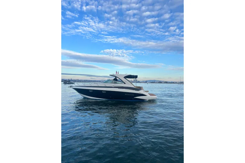 The Image of 2018 Crownline 350 SY yacht on calm water under a blue sky. - 0
