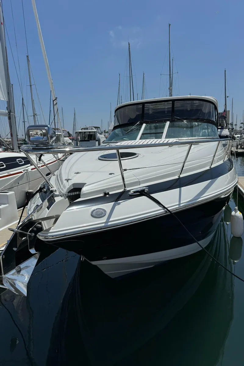 Slide: The Image of 2018 Crownline 350 SY yacht docked in a marina under a clear blue sky. - 12