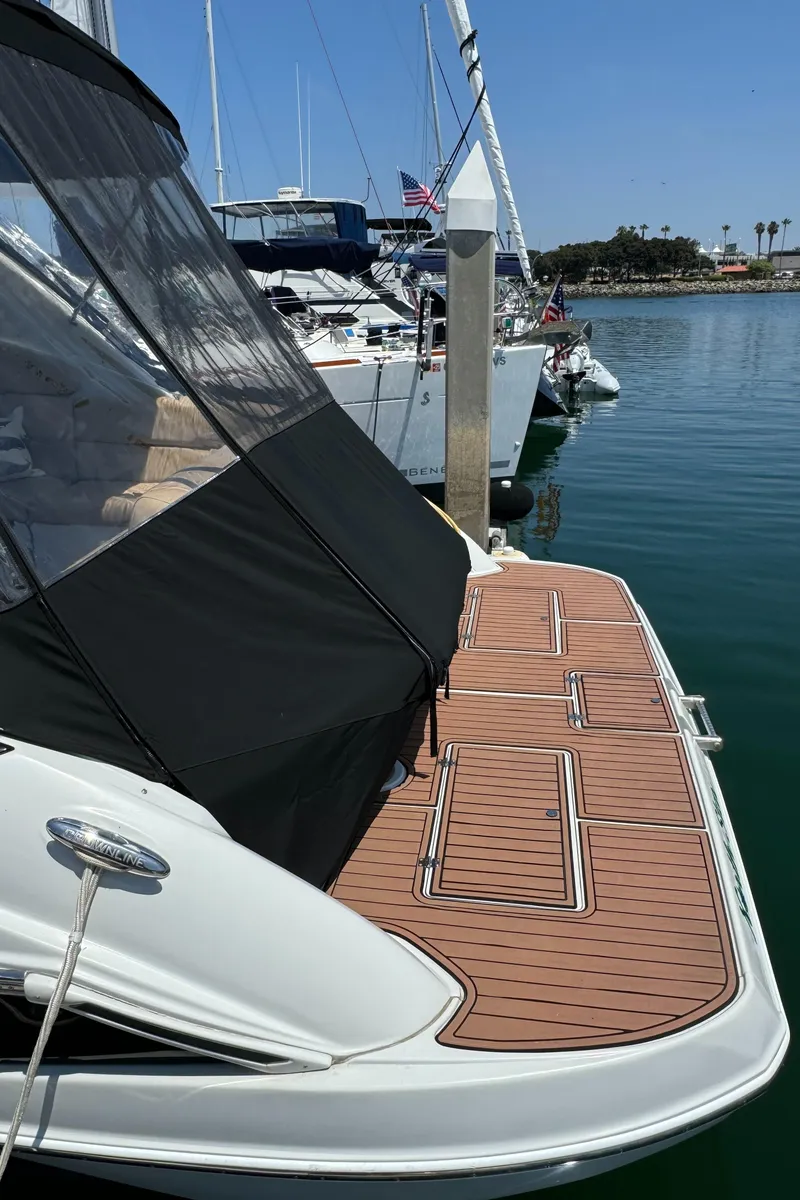 Slide: The Image of 2018 Crownline 350 SY yacht docked with teak swim platform. - 13