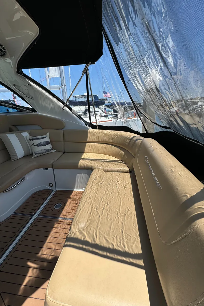 Slide: The Image of 2018 Crownline 350 SY yacht interior with beige seating and wooden flooring. - 22