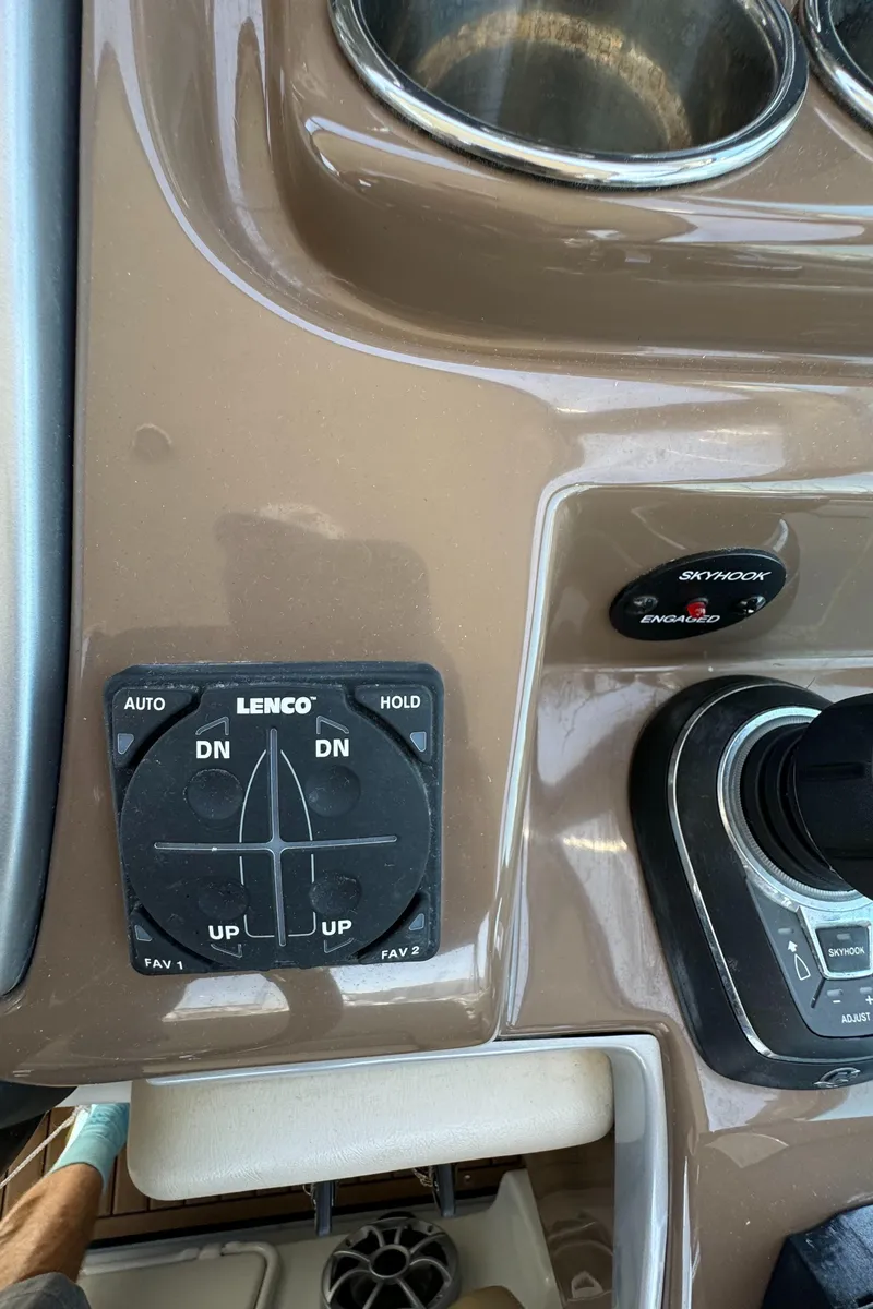 Slide: The Image of Control panel of 2018 Crownline 350 SY boat with Lenco trim tab switches. - 27