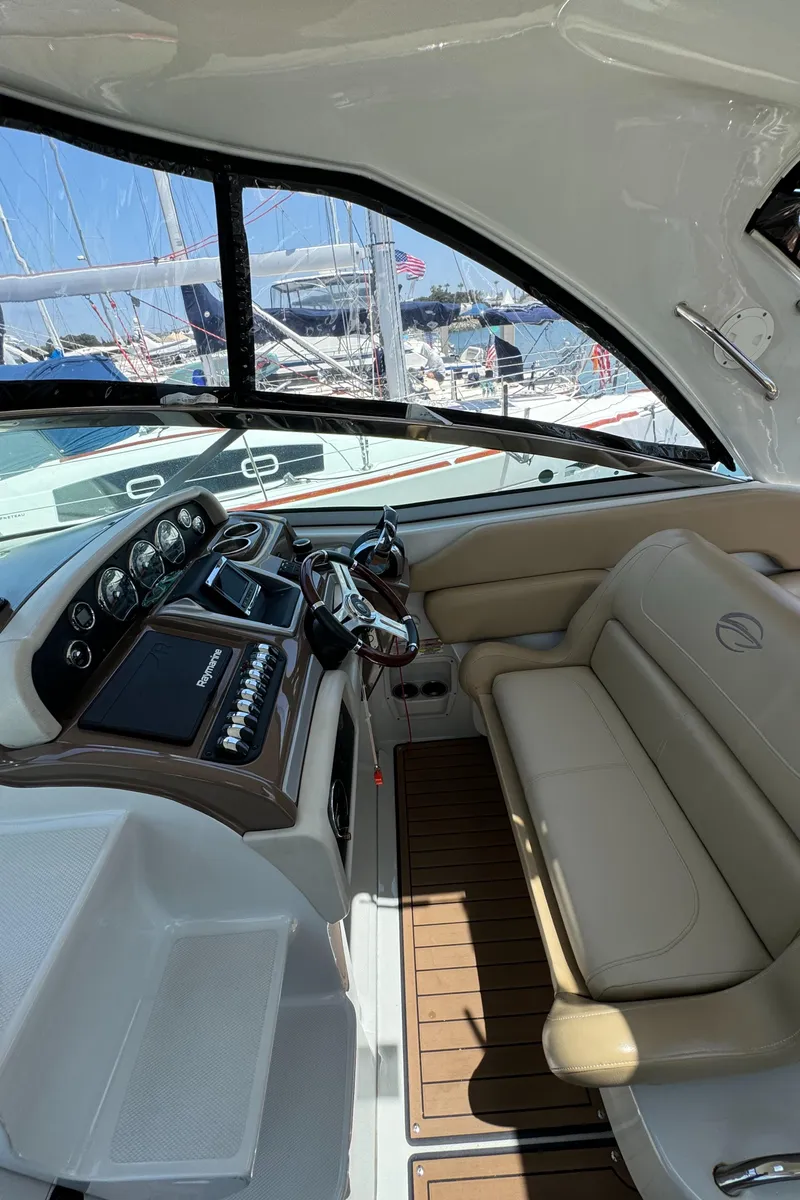 Slide: The Image of 2018 Crownline 350 SY yacht interior with helm and seating area. - 34