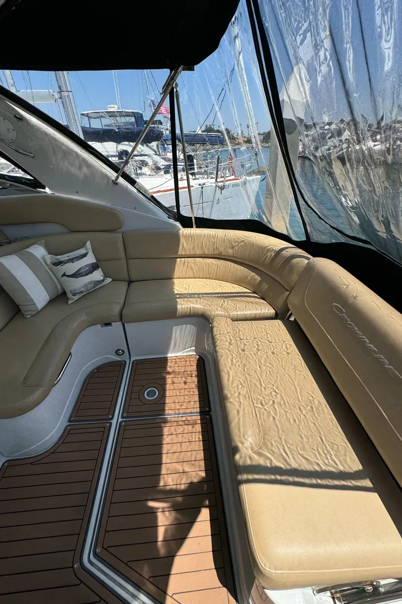 Slide: The Image of 2018 Crownline 350 SY yacht interior with beige seating and wooden flooring. - 37
