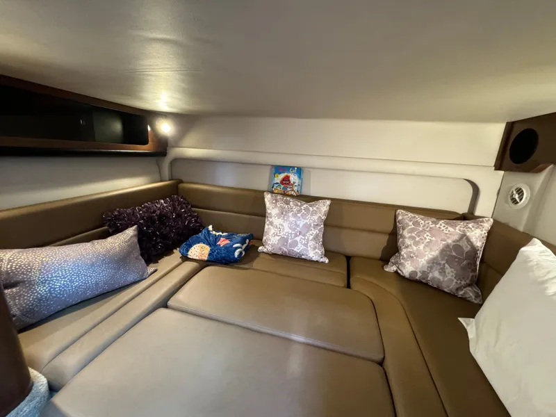Slide: The Image of Interior cabin of 2018 Crownline 350 SY with cozy seating and decorative pillows. - 43