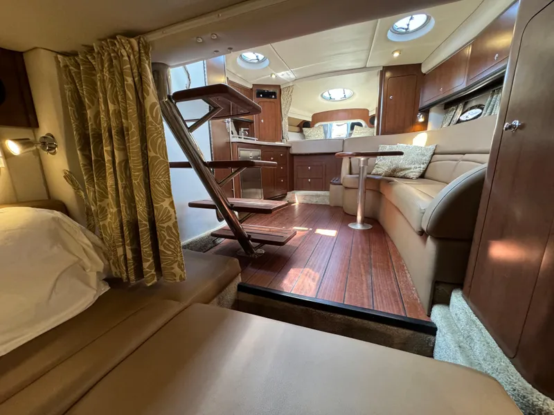Slide: The Image of Luxurious interior of 2018 Crownline 350 SY yacht with elegant wood finishes and cozy seating. - 44