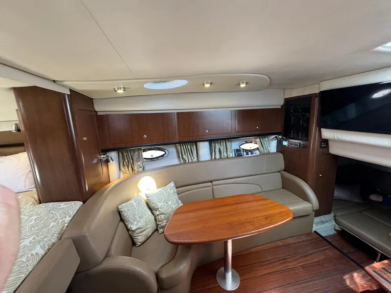 Slide: The Image of Interior of 2018 Crownline 350 SY yacht with cozy seating and wooden table. - 45