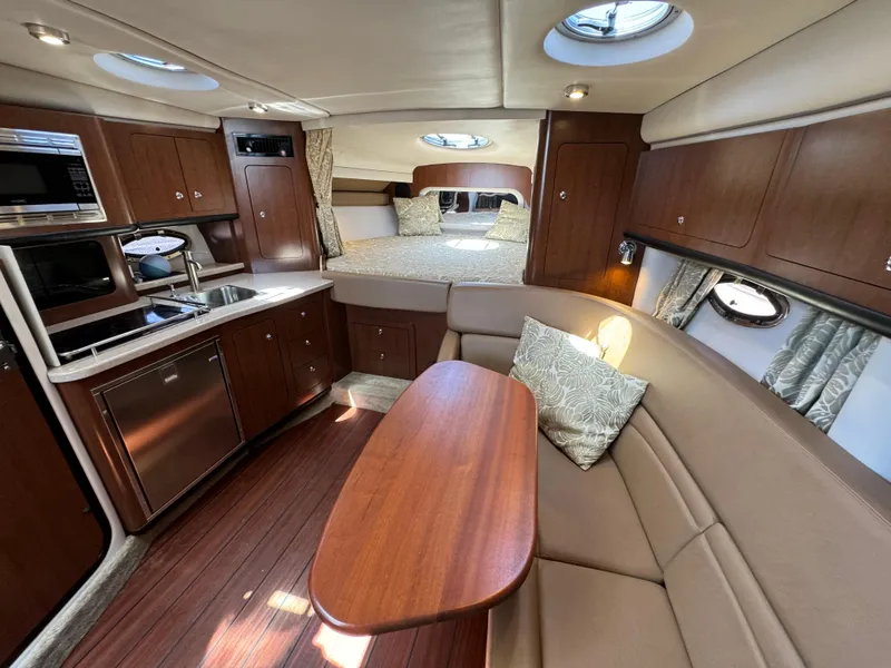 Slide: The Image of Luxurious interior of 2018 Crownline 350 SY yacht with kitchen, seating, and bed. - 46
