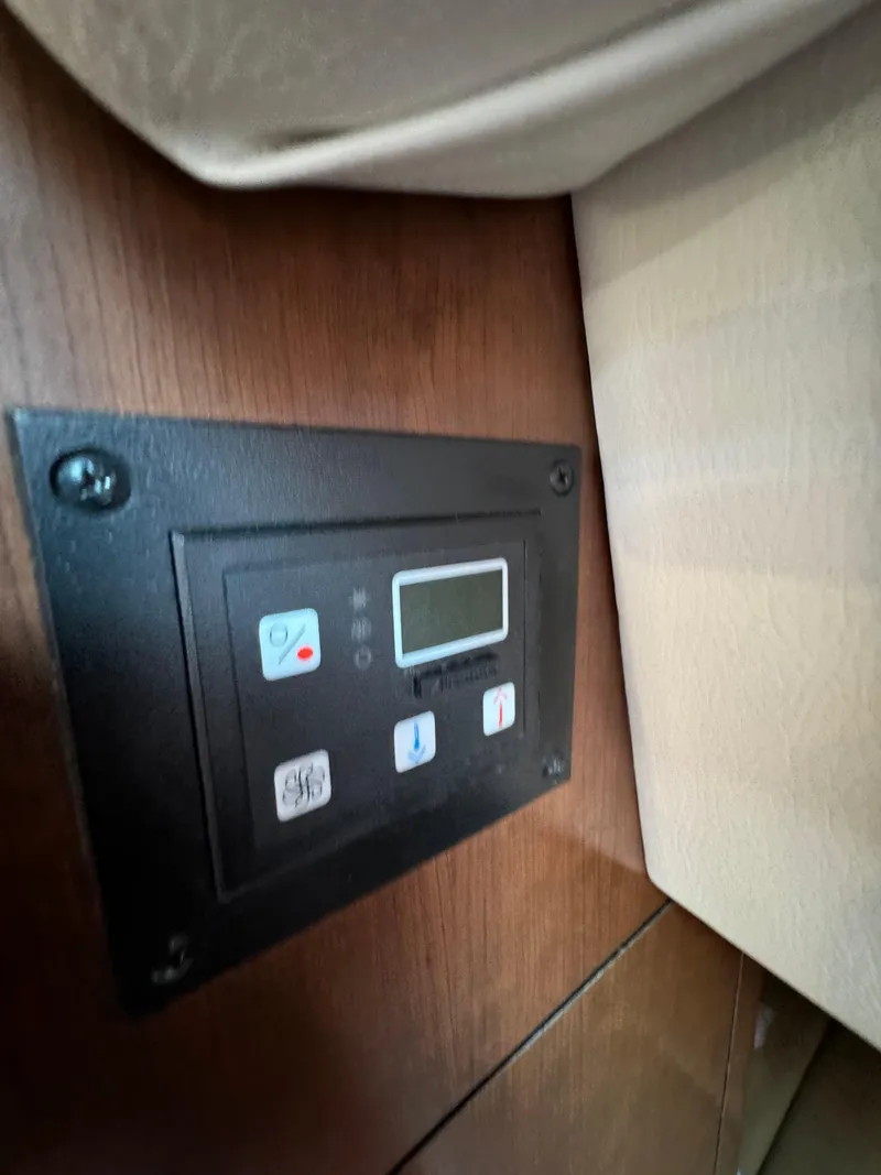 Slide: The Image of Control panel inside 2018 Crownline 350 SY boat, featuring digital display and buttons. - 49