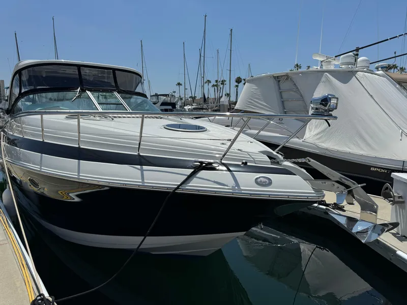 Slide: The Image of 2018 Crownline 350 SY yacht docked at marina, clear sky, calm water. - 7