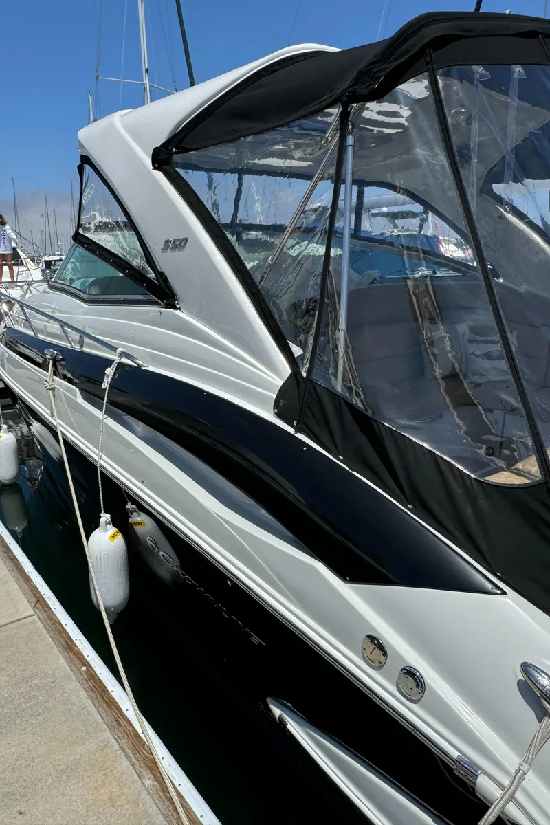 Slide: The Image of 2018 Crownline 350 SY yacht docked at marina, featuring sleek design and modern canopy. - 8