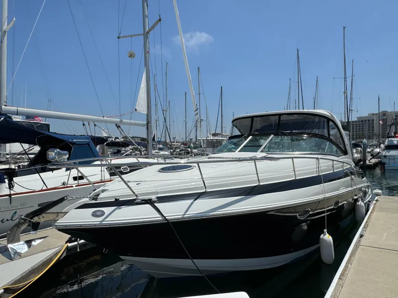 Slide: The Image of 2018 Crownline 350 SY yacht docked at marina under clear blue sky. - 9