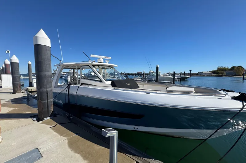Slide: The Image of 2020 Boston Whaler 420 Outrage docked at marina under clear blue sky. - 1