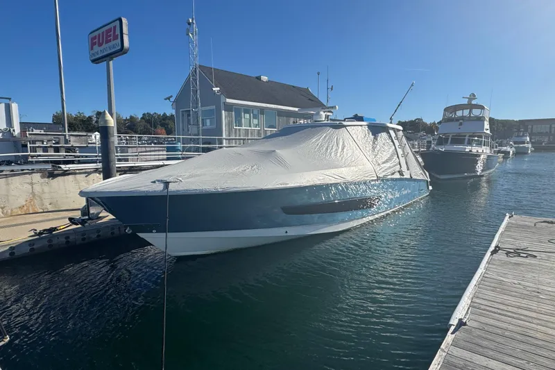Slide: The Image of 2020 Boston Whaler 420 Outrage docked, covered, near fuel station. - 10