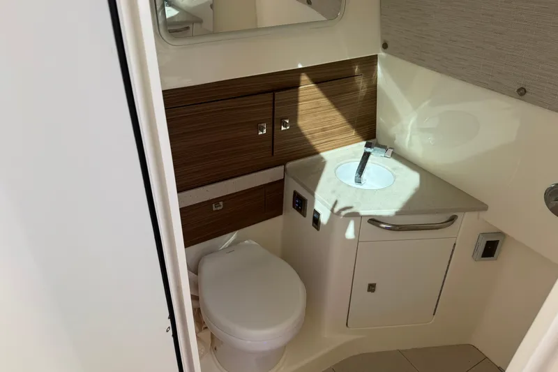 Slide: The Image of 2020 Boston Whaler 420 Outrage bathroom with modern sink and toilet. - 15