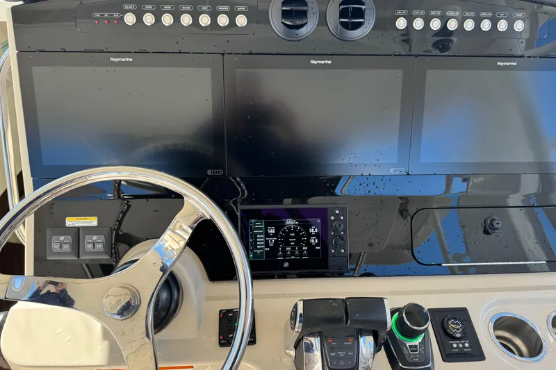 Slide: The Image of Boston Whaler 420 Outrage 2020 helm with Raymarine displays and steering wheel. - 25