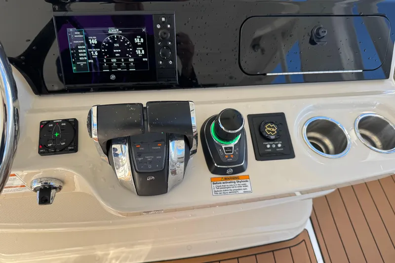 Slide: The Image of Control panel of 2020 Boston Whaler 420 Outrage with navigation and throttle controls. - 26