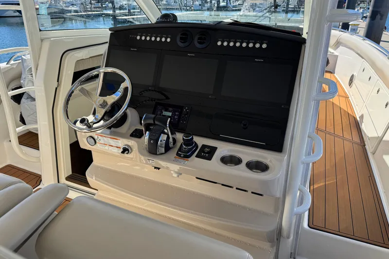 Slide: The Image of 2020 Boston Whaler 420 Outrage helm with modern controls and navigation screens. - 28