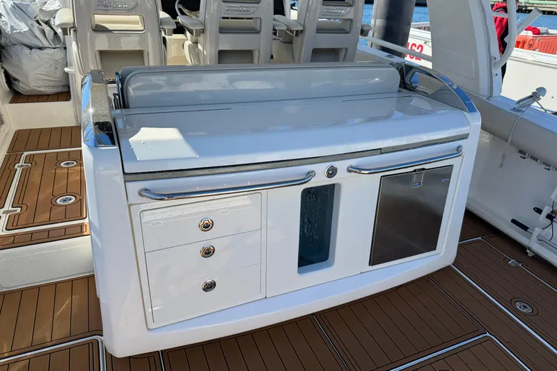 Slide: The Image of 2020 Boston Whaler 420 Outrage boat interior with sleek cabinetry and seating. - 33