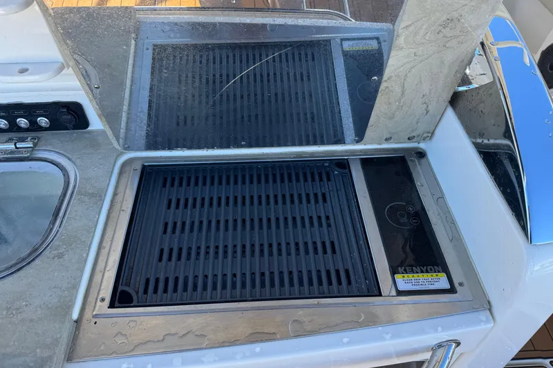 Slide: The Image of Kenyon grill on 2020 Boston Whaler 420 Outrage boat, featuring sleek design and controls. - 34