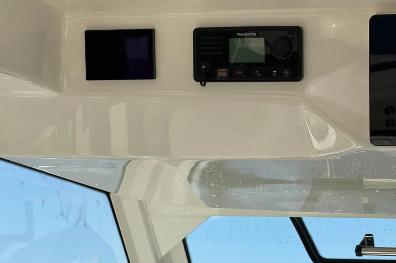 Slide: The Image of 2020 Boston Whaler 420 Outrage dashboard with Raymarine electronics and clear windshield view. - 38