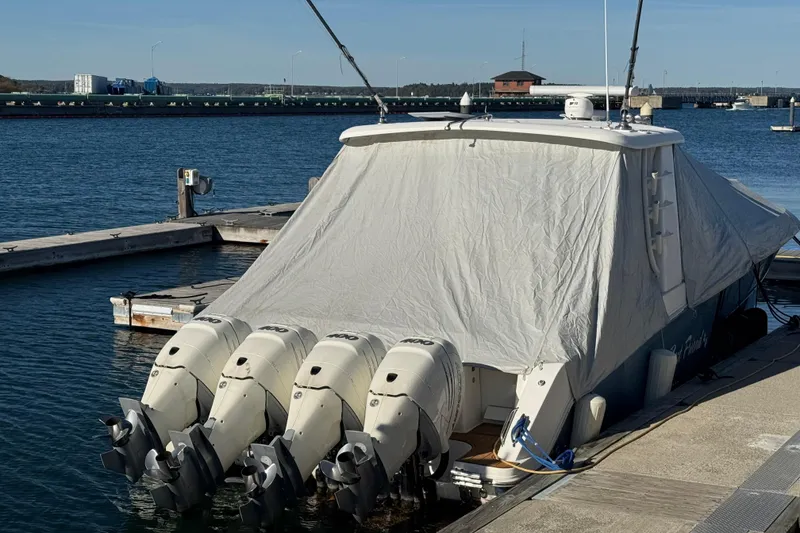 Slide: The Image of 2020 Boston Whaler 420 Outrage covered at dock with four outboard engines. - 40