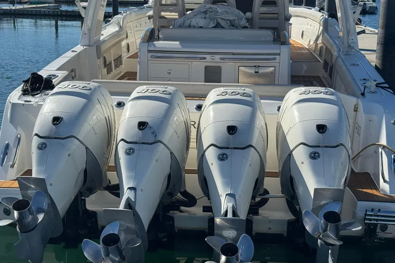 Slide: The Image of 2020 Boston Whaler 420 Outrage with four powerful outboard engines at the dock. - 5