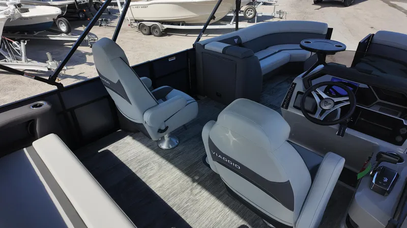 Slide: The Image of Interior of 2025 Viaggio X22S boat with modern seating and steering wheel. - 10