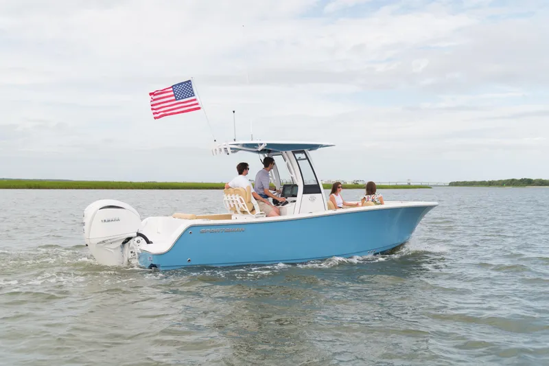 The Image of 2026 Sportsman Open 232 Center Console boat cruising with passengers, American flag flying. - 0