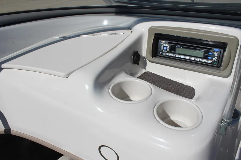Slide: The Image of 2008 Tahoe Q5i SF boat dashboard with stereo and cup holders. - 13