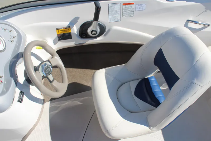 Slide: The Image of 2008 Tahoe Q5i SF boat interior with steering wheel and cushioned seat. - 14