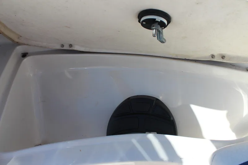 Slide: The Image of 2008 Tahoe Q5i SF boat storage compartment with latch and black mat. - 18