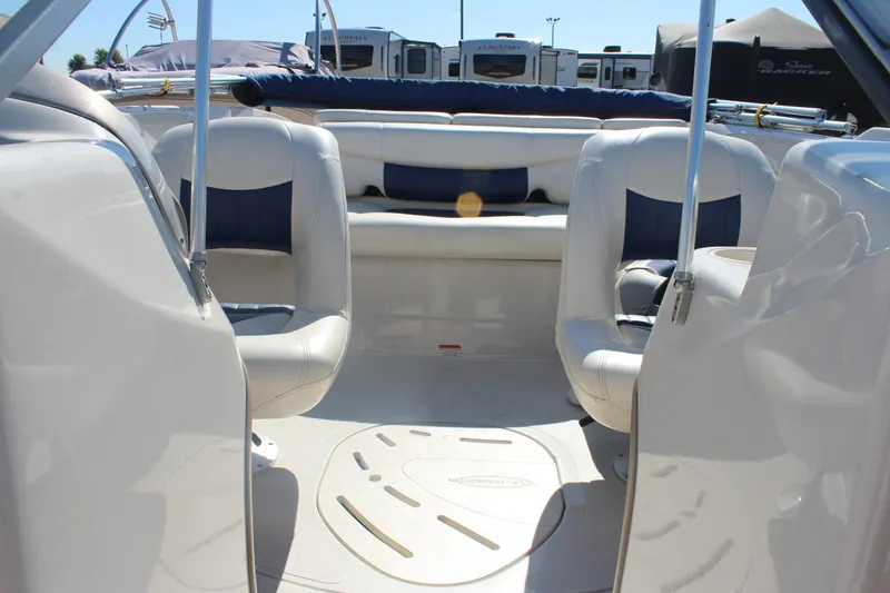 Slide: The Image of 2008 Tahoe Q5i SF boat interior with white and blue seating, parked outdoors. - 20