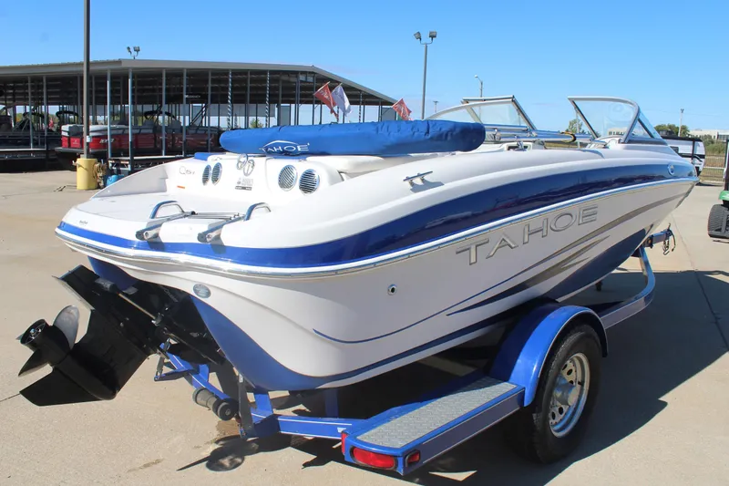 Slide: The Image of 2008 Tahoe Q5i SF boat on trailer, parked outdoors under clear sky. - 4