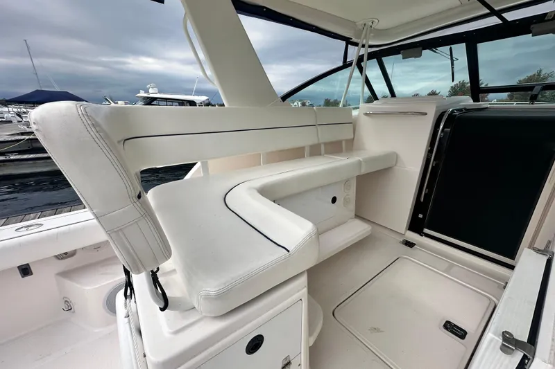 Slide: The Image of 2004 Tiara Yachts 3500 Open interior with white seating and sleek design. - 10