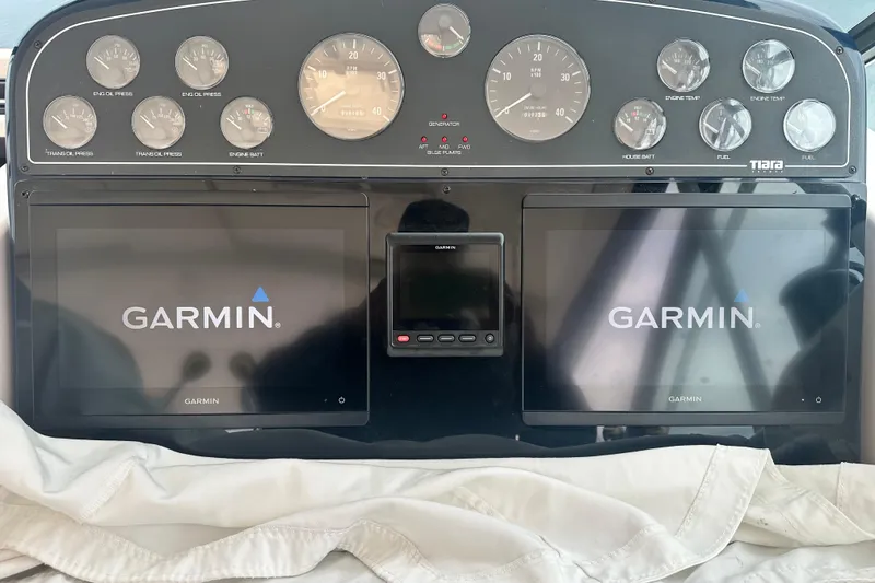 Slide: The Image of Dashboard of a 2004 Tiara Yachts 3500 Open with Garmin displays and gauges. - 19