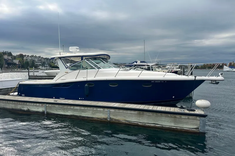 Slide: The Image of 2004 Tiara Yachts 3500 Open docked on a cloudy day, showcasing sleek design. - 2
