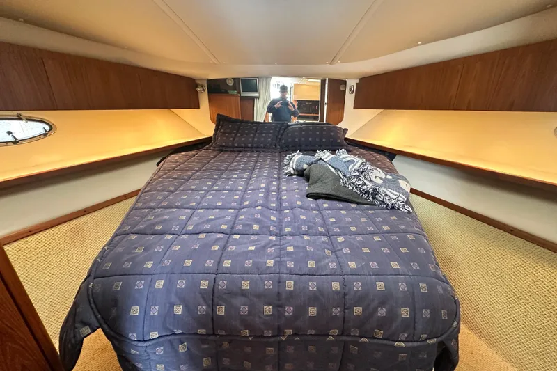 Slide: The Image of 2004 Tiara Yachts 3500 Open cabin with cozy bed and wooden interior. - 22