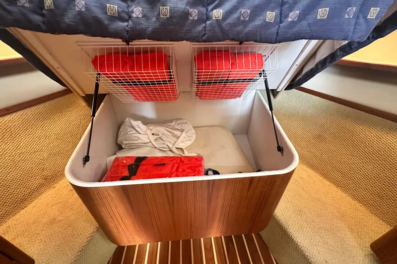 Slide: The Image of 2004 Tiara Yachts 3500 Open cabin storage with life jackets and bedding. - 23