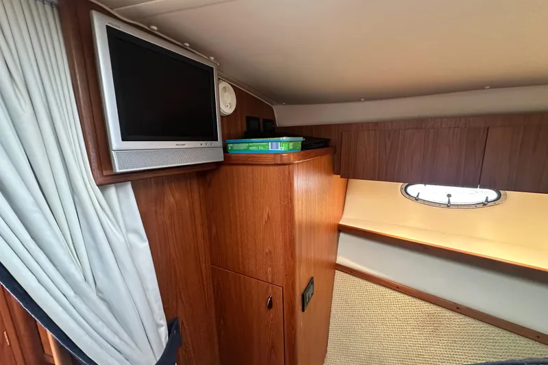 Slide: The Image of 2004 Tiara Yachts 3500 Open cabin interior with TV and porthole window. - 25