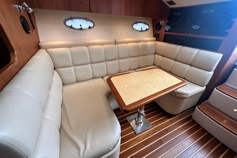Slide: The Image of Luxurious interior of 2004 Tiara Yachts 3500 Open with plush seating and wooden accents. - 27
