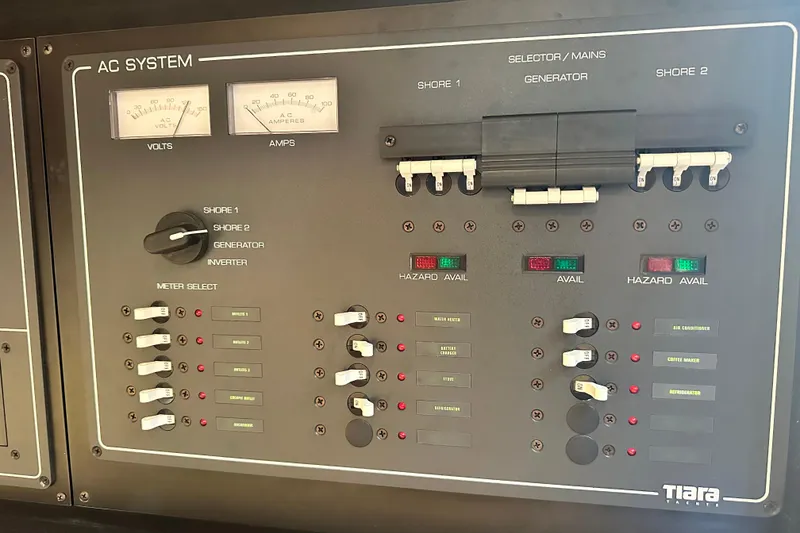 Slide: The Image of Electrical control panel of a 2004 Tiara Yachts 3500 Open, featuring AC system gauges. - 28
