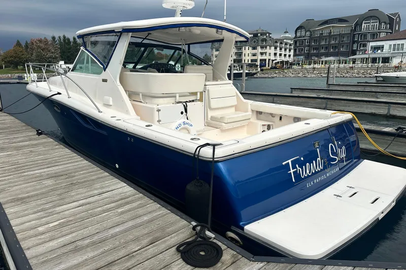 Slide: The Image of 2004 Tiara Yachts 3500 Open docked, featuring sleek design and spacious deck. - 3