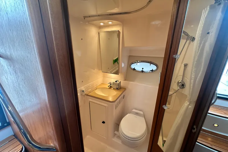 Slide: The Image of 2004 Tiara Yachts 3500 Open bathroom with sink, toilet, and shower. - 30