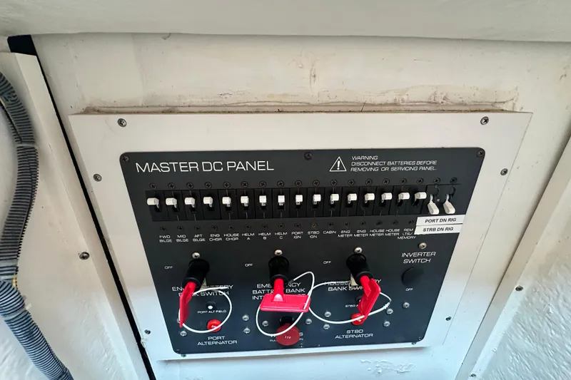 Slide: The Image of Master DC panel on 2004 Tiara Yachts 3500 Open, featuring switches and warning labels. - 32