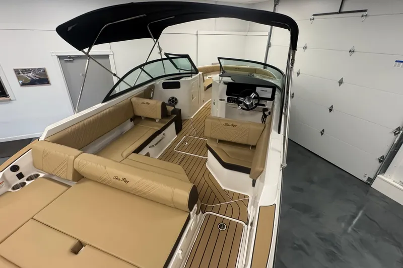 Slide: The Image of 2026 Sea Ray SDX 230 Outboard boat interior with tan seating and sleek design. - 10